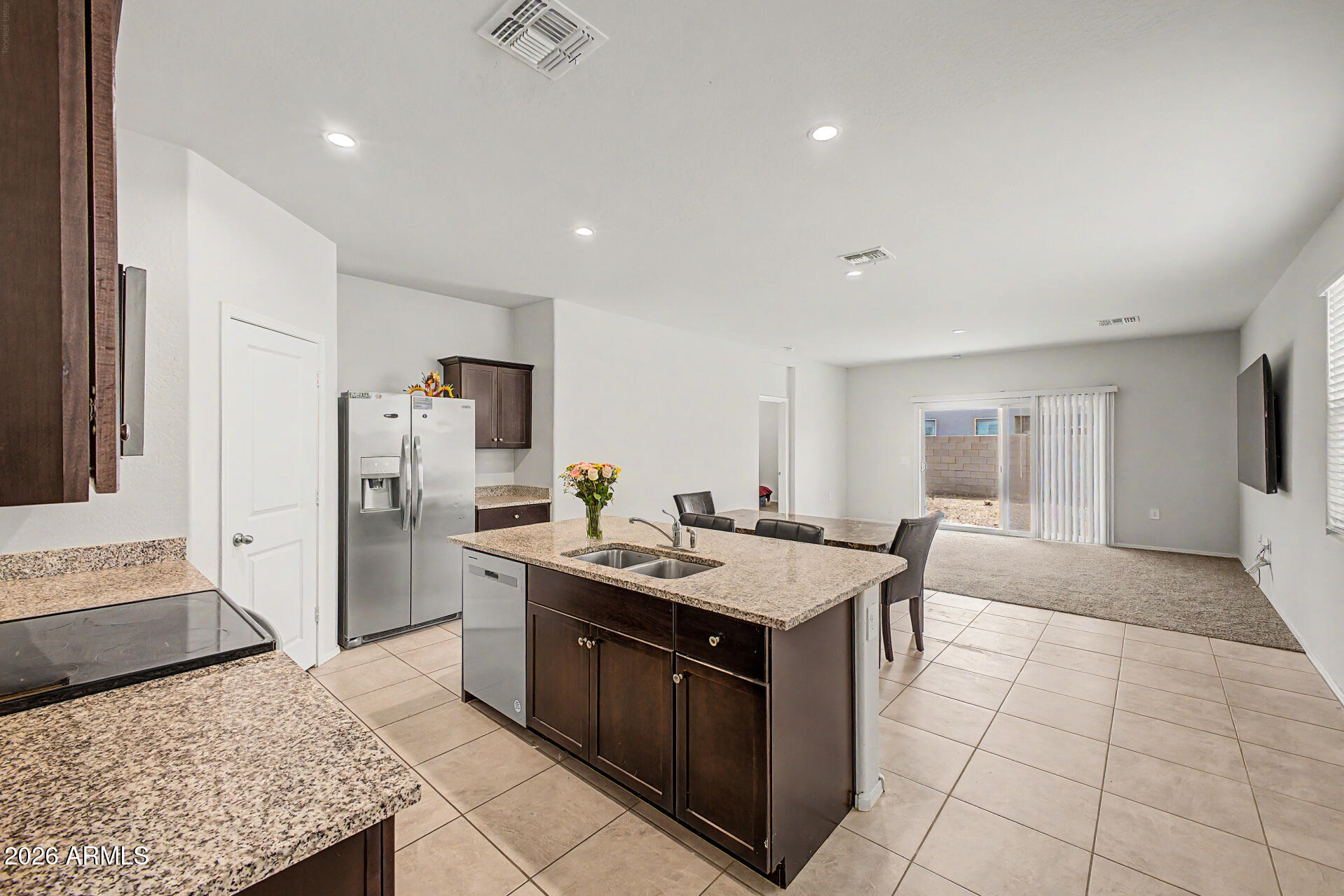 9345 Tangerine Road Florence, AZ 85132 - Photo 12 of 30 a kitchen with stainless steel appliances granite countertop a sink and a stove