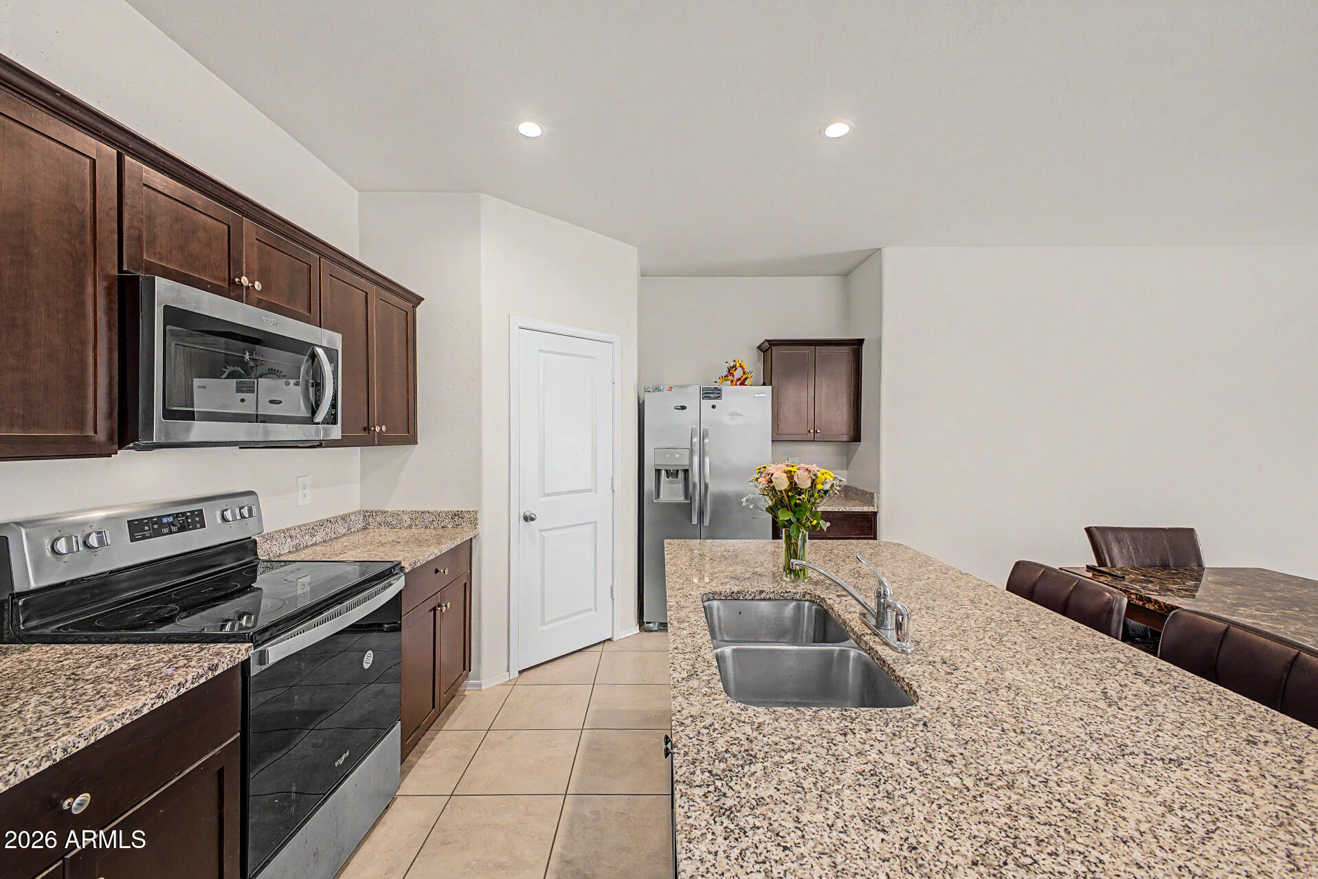 9345 Tangerine Road Florence, AZ 85132 - Photo 14 of 30 a kitchen with a sink stove and refrigerator