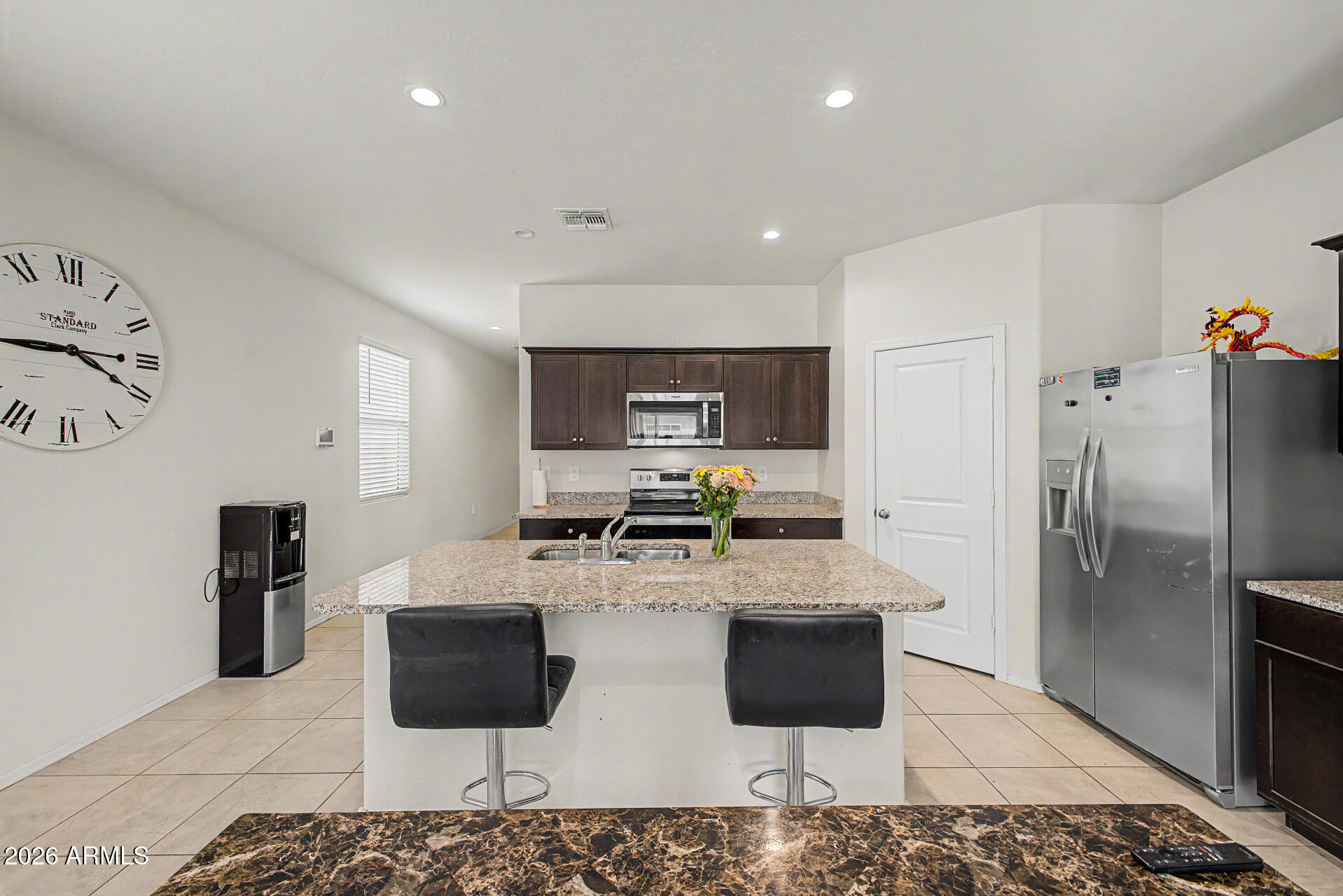 9345 Tangerine Road Florence, AZ 85132 - Photo 15 of 30 a kitchen with stainless steel appliances kitchen island granite countertop a refrigerator and a stove top oven
