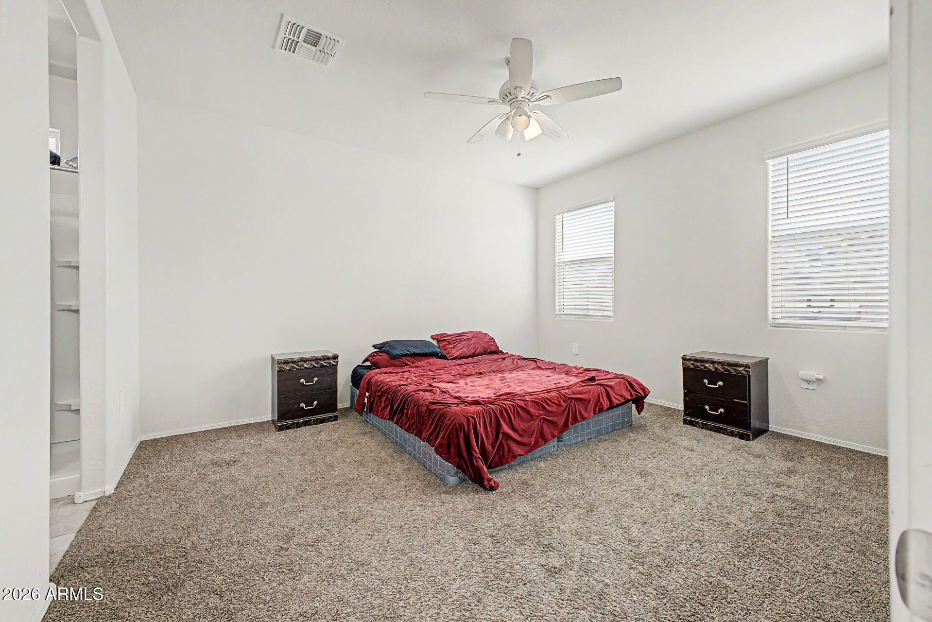 9345 Tangerine Road Florence, AZ 85132 - Photo 16 of 30 a spacious bedroom with a bed and a chandelier