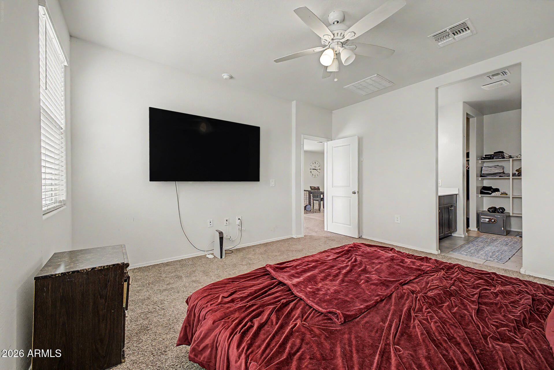 9345 Tangerine Road Florence, AZ 85132 - Photo 17 of 30 a bedroom with a bed and a flat tv screen on wall