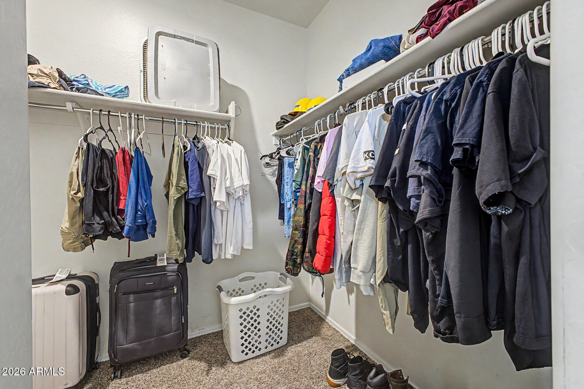 9345 Tangerine Road Florence, AZ 85132 - Photo 19 of 30 a view of walk in closet with clothes and shoes
