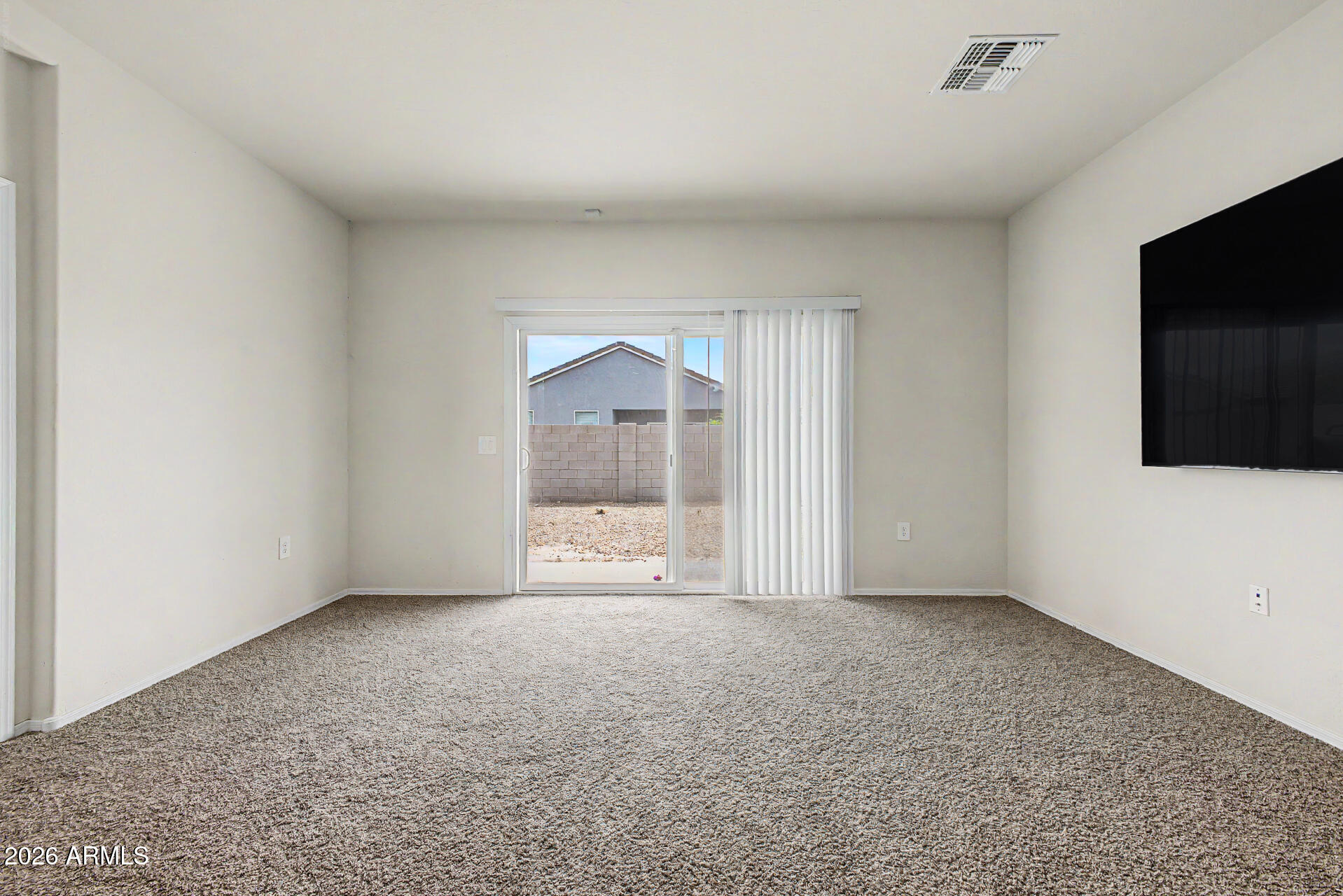 9345 Tangerine Road Florence, AZ 85132 - Photo 8 of 30 a view of an empty room with a flat screen tv