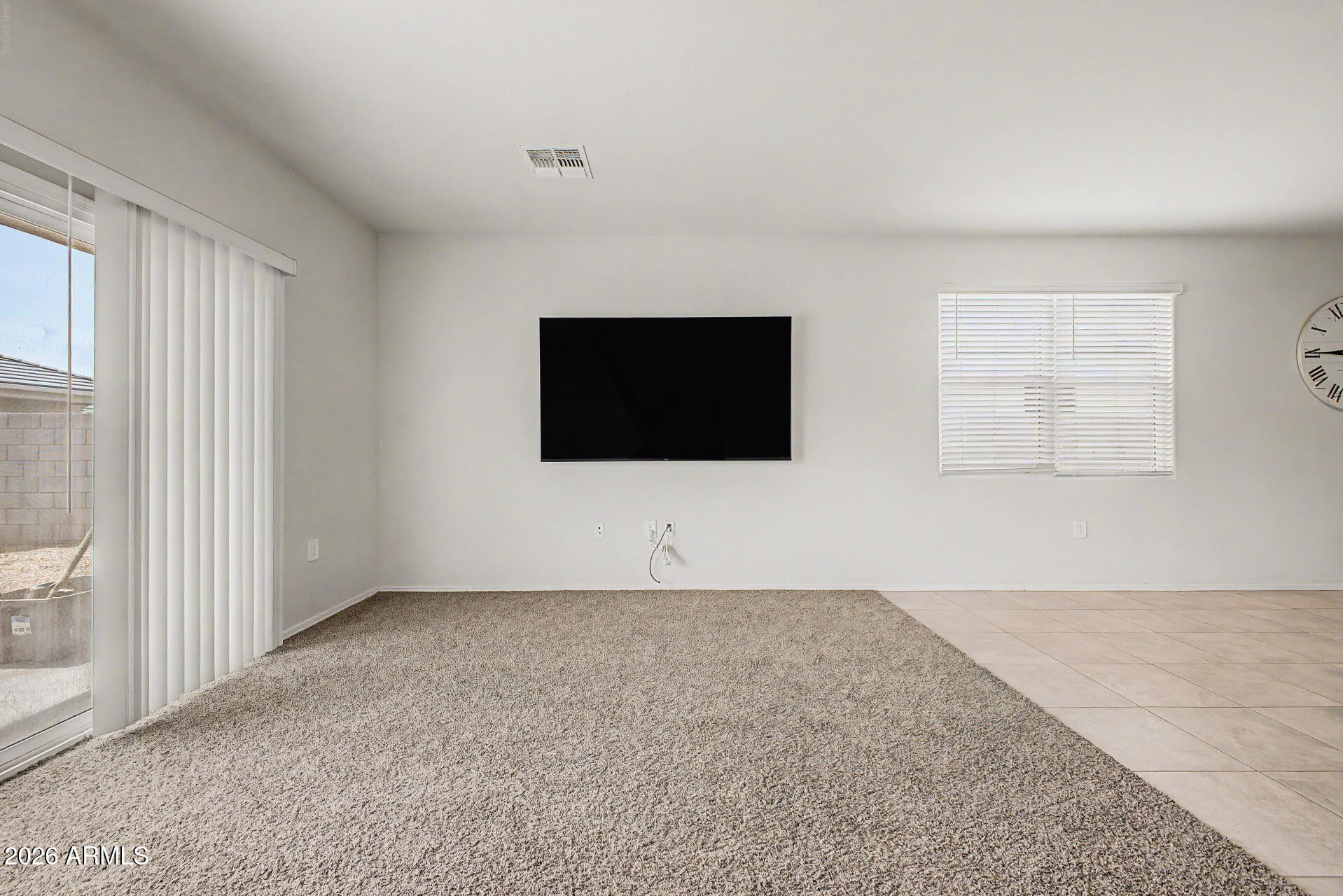 9345 Tangerine Road Florence, AZ 85132 - Photo 9 of 30 a living room with a flat screen tv and a window