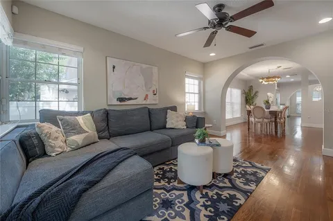 a living room with furniture and a book shelf
