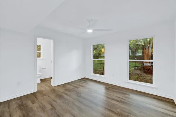 a kitchen with stainless steel appliances granite countertop a stove and a wooden floors
