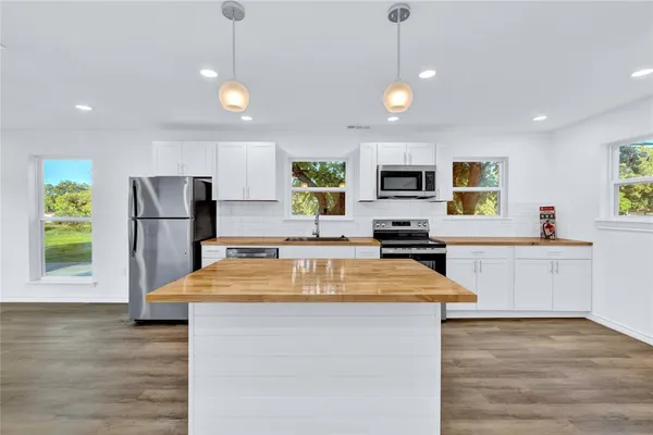 a kitchen with a refrigerator a sink and dishwasher