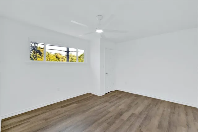 a kitchen with refrigerator cabinets and wooden floor