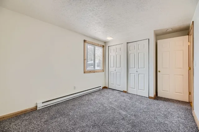 an empty room with a empty space and windows