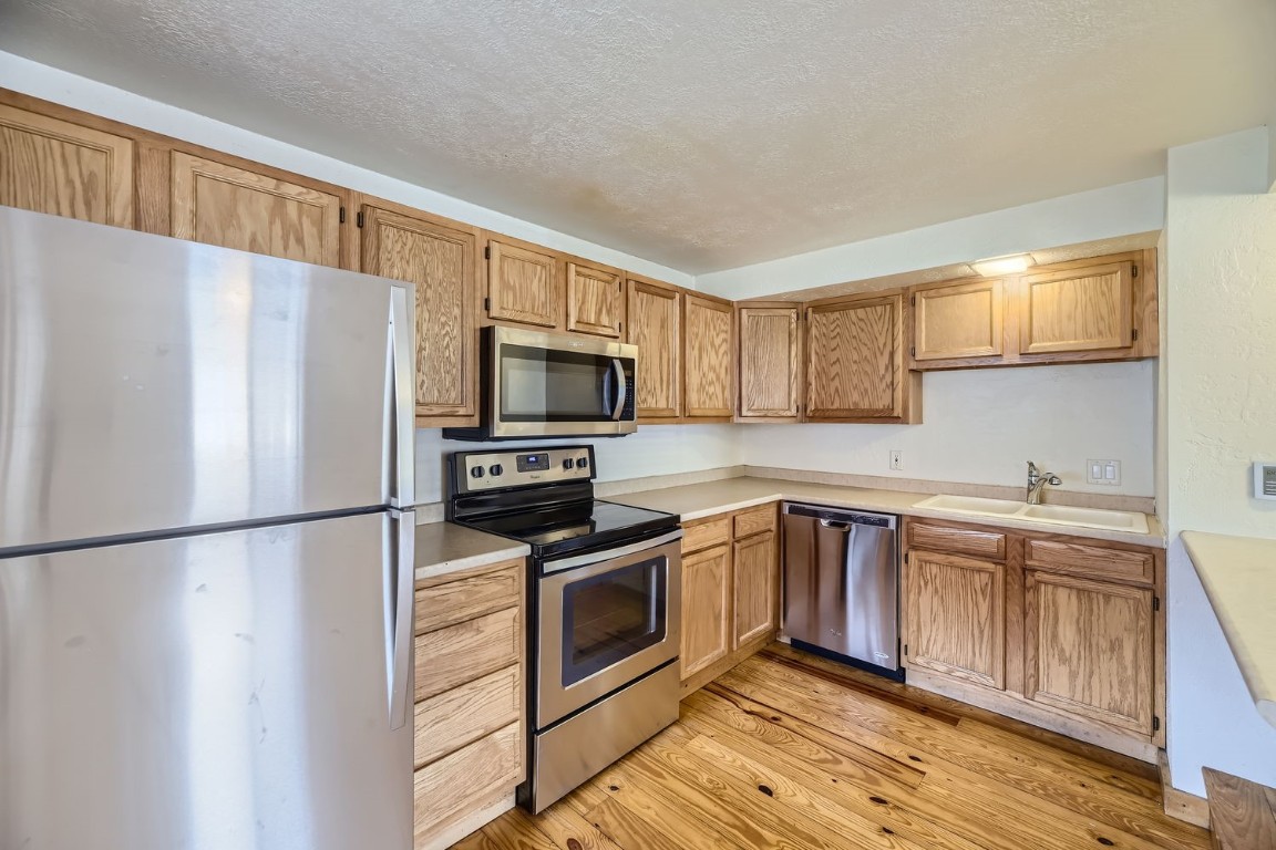 707 Frisco Street, Unit 45 Frisco, CO 80443 - Photo 8 of 18 a kitchen with stainless steel appliances a refrigerator stove microwave and sink