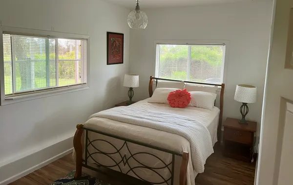 a bedroom with a bed and a window