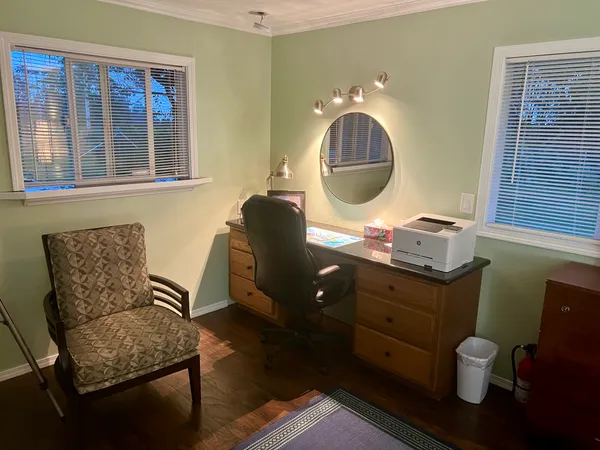 a living room with furniture and a mirror