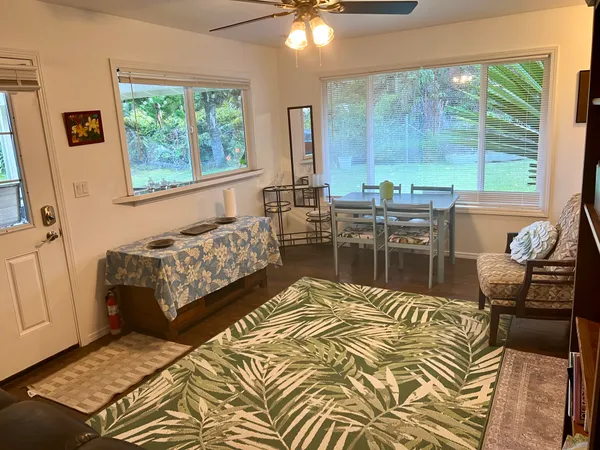 a bedroom with a bed and large windows