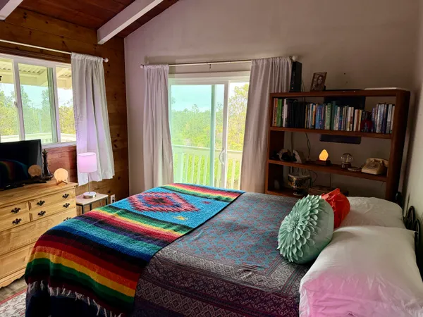 a bedroom with a bed furniture and a book shelf