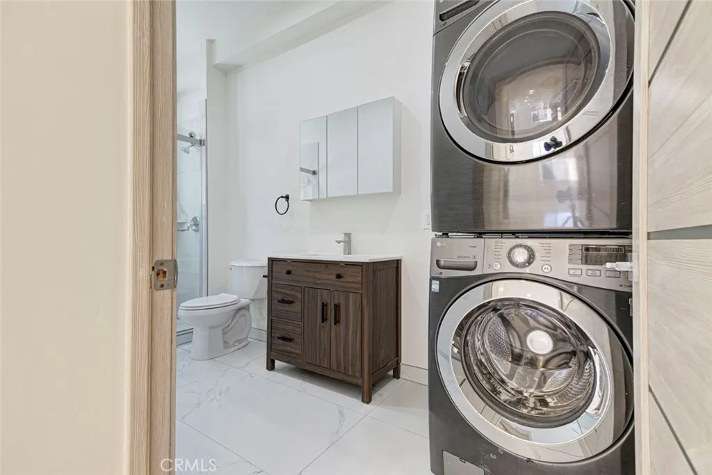 7044 Greeley Street Tujunga, CA 91042 - Photo 13 of 27 a view of a hallway with washer and dryer