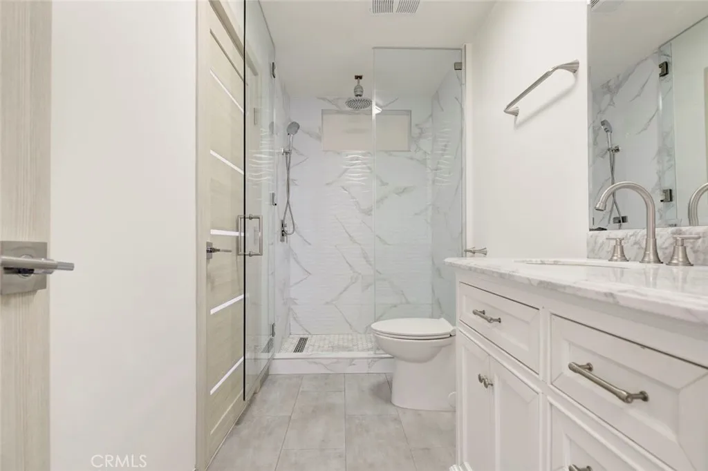 7044 Greeley Street Tujunga, CA 91042 - Photo 21 of 27 a bathroom with a granite countertop sink toilet and shower