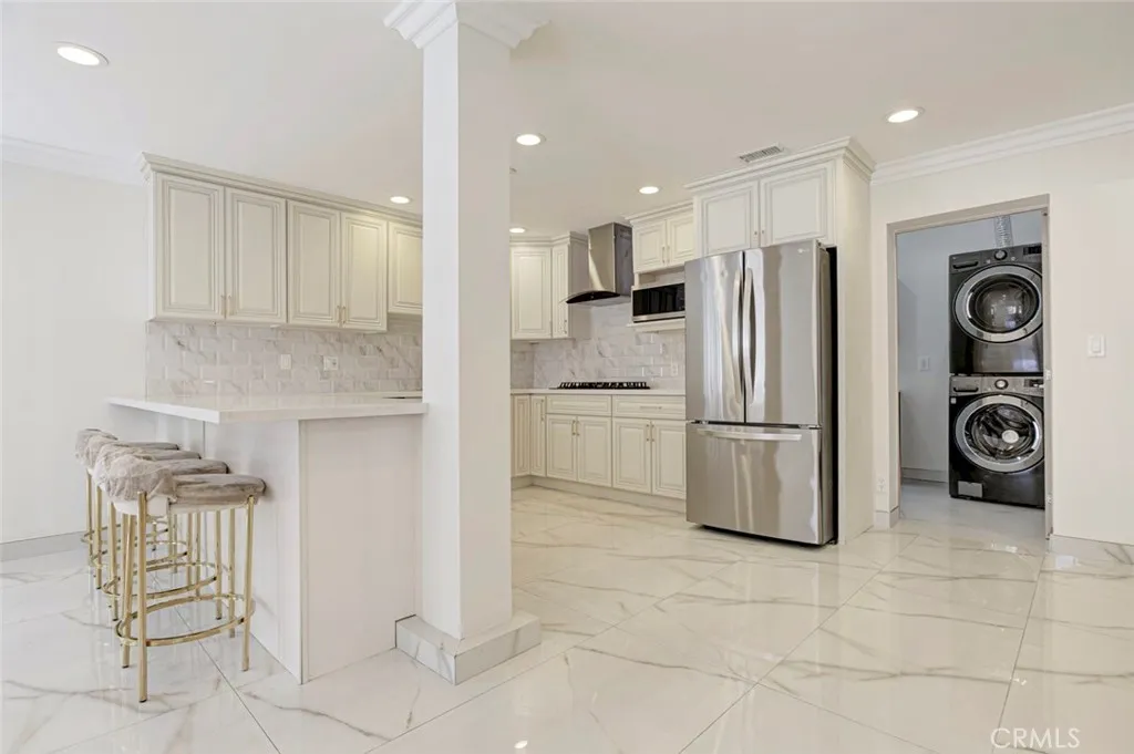 7044 Greeley Street Tujunga, CA 91042 - Photo 9 of 27 a kitchen with stainless steel appliances granite countertop a refrigerator and a stove