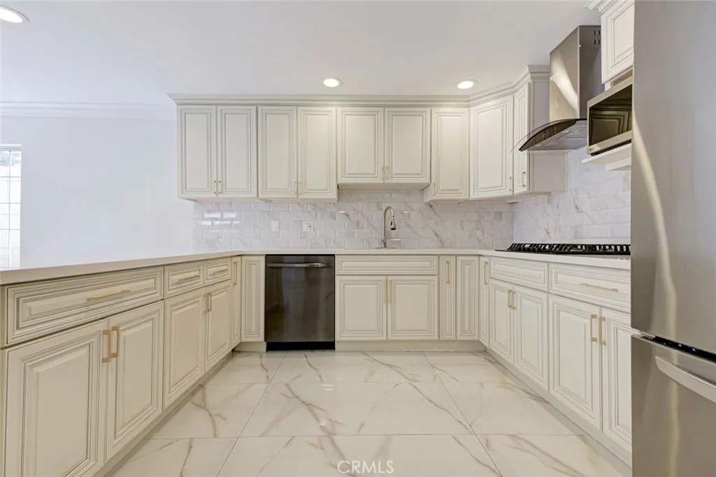 7044 Greeley Street Tujunga, CA 91042 - Photo 10 of 27 a kitchen with white cabinets appliances and a sink
