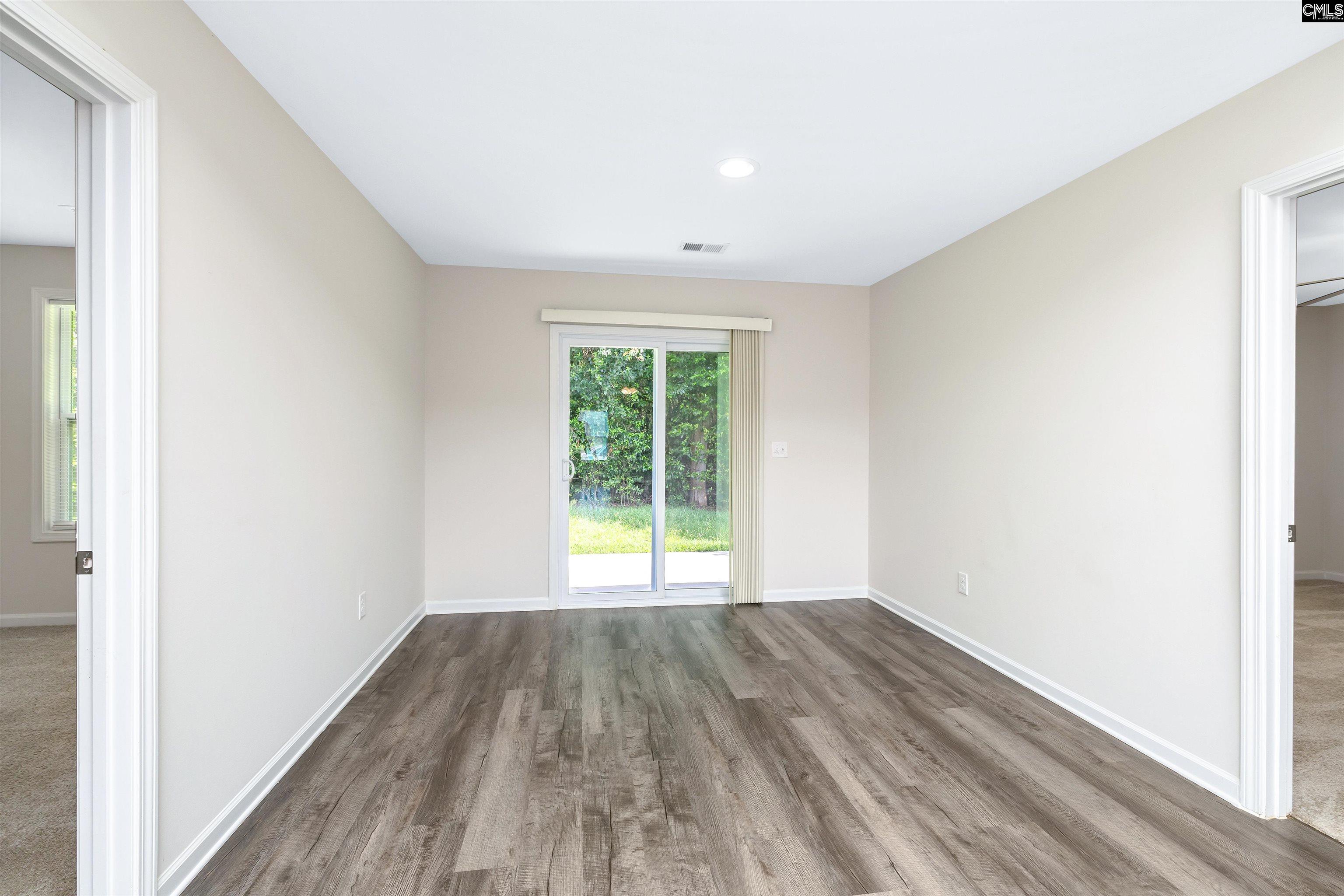 2157 Still Pointe Drive Sumter, SC 29154 - Photo 14 of 25 a view of an empty room with wooden floor and a window