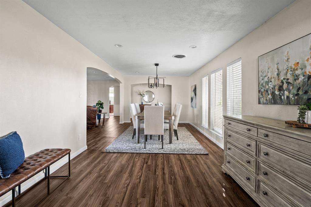 10 Estates Road Lucas, TX 75002 - Photo 5 of 39 Dining room with arched walkways and dark wood finished floors