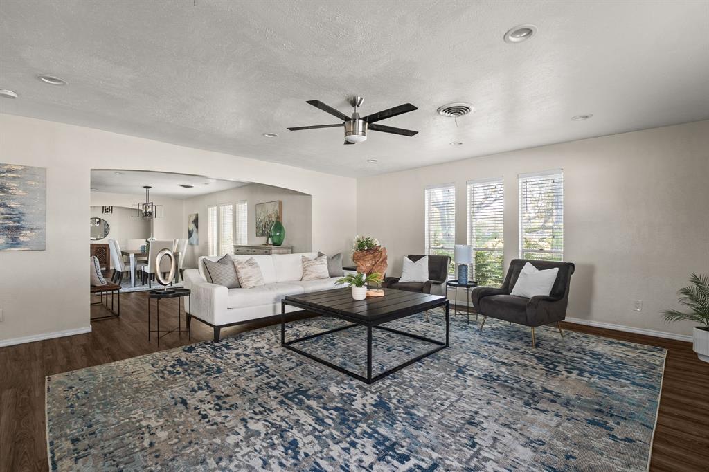 10 Estates Road Lucas, TX 75002 - Photo 7 of 39 Living room featuring dark wood finished floors, arched walkways, a textured ceiling, and a ceiling fan