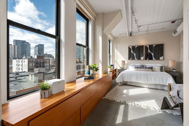 a view of living room with furniture and large windows