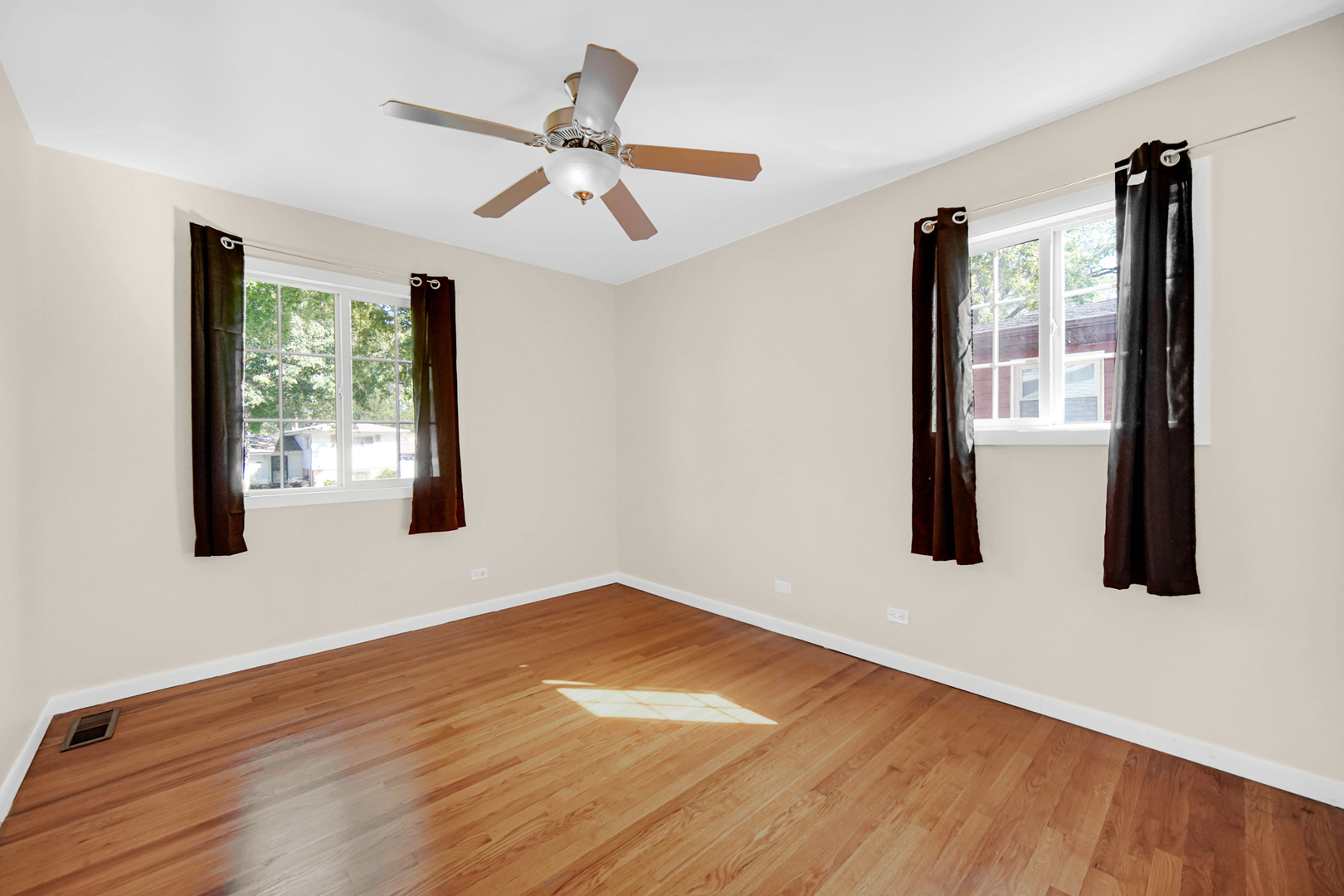 120 Indiana Street Park Forest, IL 60466 - Photo 12 of 25 a view of an empty room with wooden floor and a window