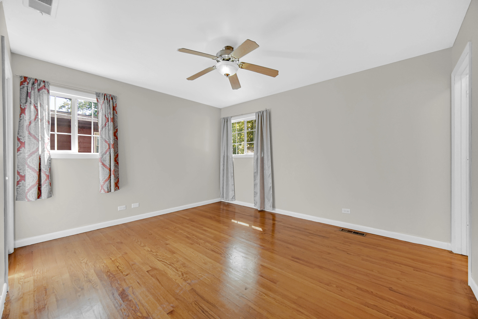 120 Indiana Street Park Forest, IL 60466 - Photo 14 of 25 a view of an empty room with wooden floor and a window