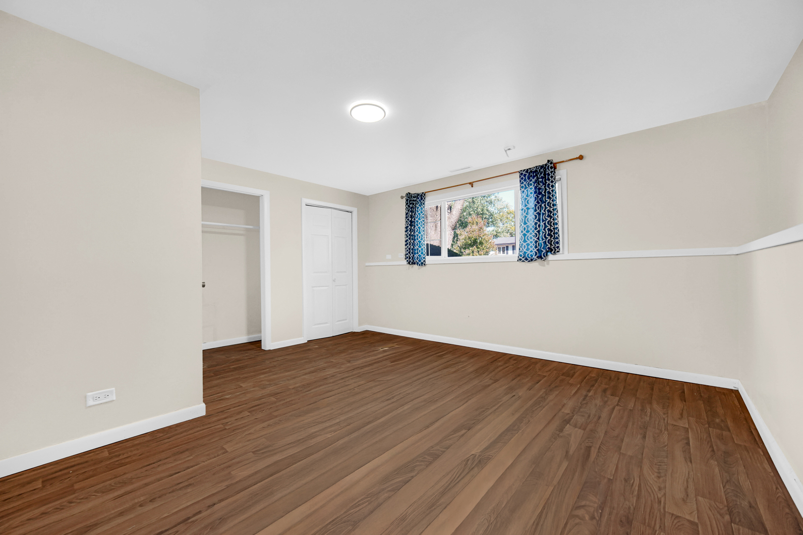 120 Indiana Street Park Forest, IL 60466 - Photo 16 of 25 a view of an empty room with wooden floor and a window