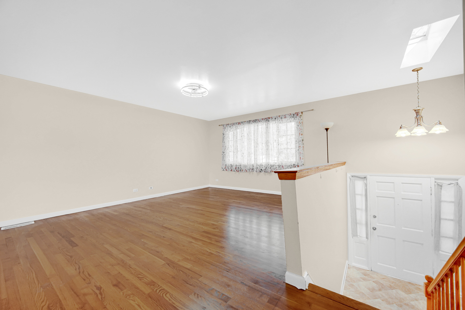 120 Indiana Street Park Forest, IL 60466 - Photo 3 of 25 an empty room with wooden floor and windows