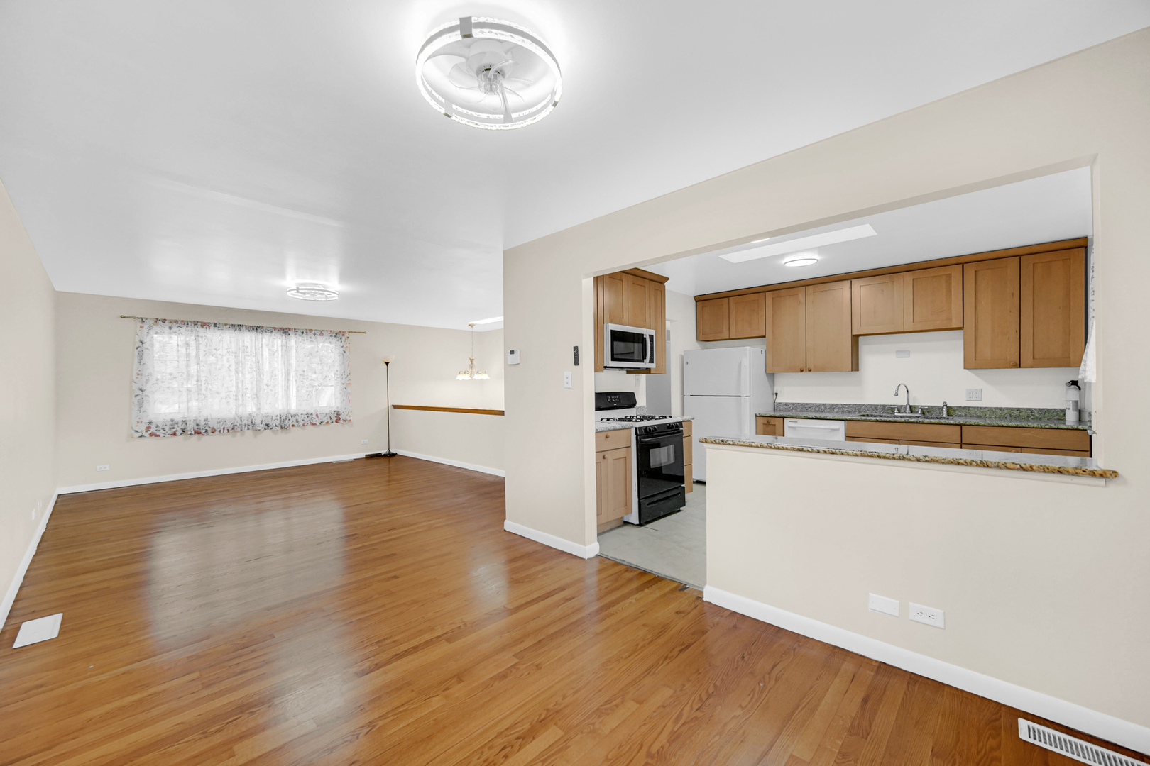 120 Indiana Street Park Forest, IL 60466 - Photo 6 of 25 a kitchen with stainless steel appliances granite countertop a refrigerator and a stove top oven