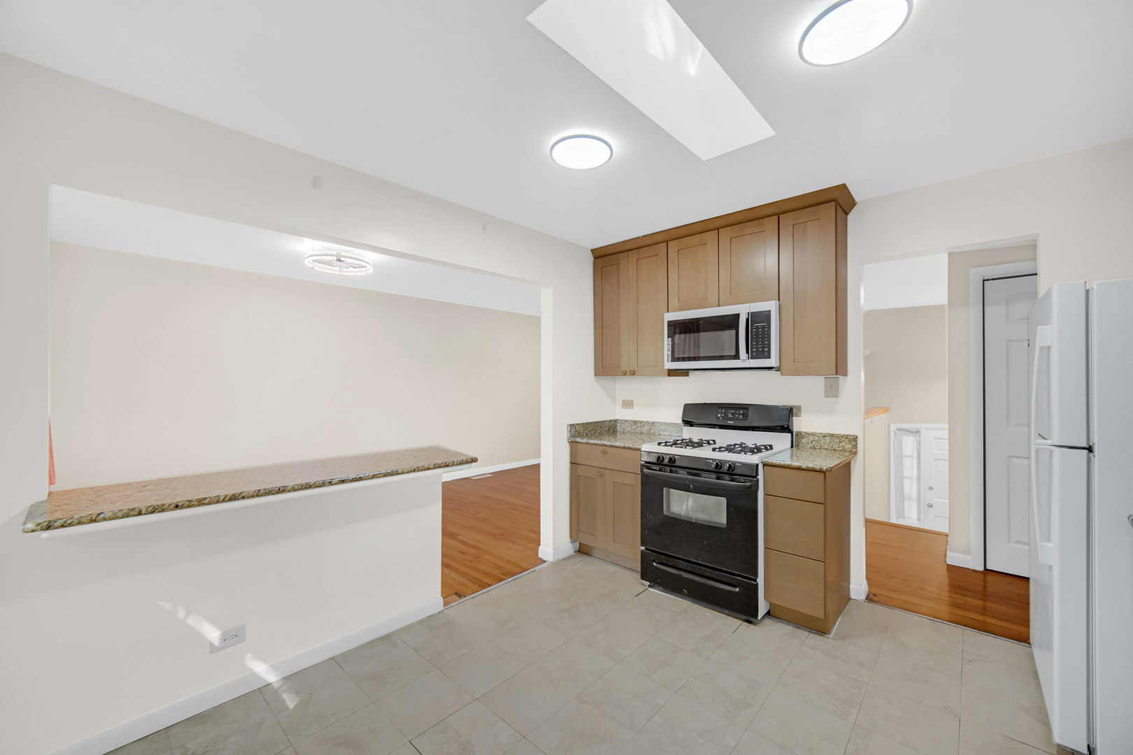 120 Indiana Street Park Forest, IL 60466 - Photo 7 of 25 a kitchen with stainless steel appliances granite countertop a stove and a refrigerator