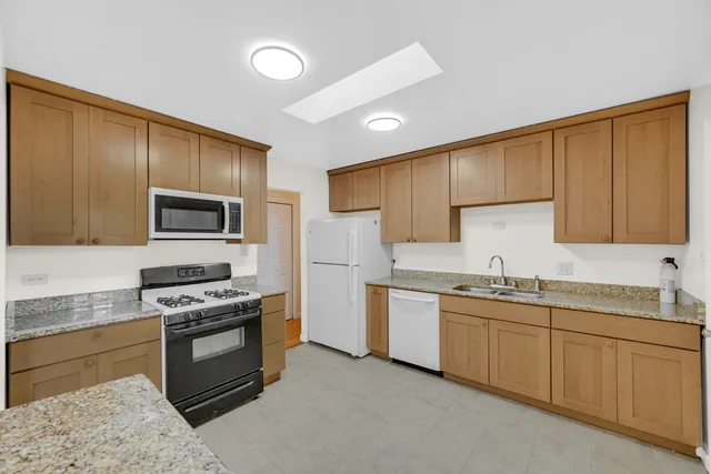 a kitchen with a sink stove and microwave