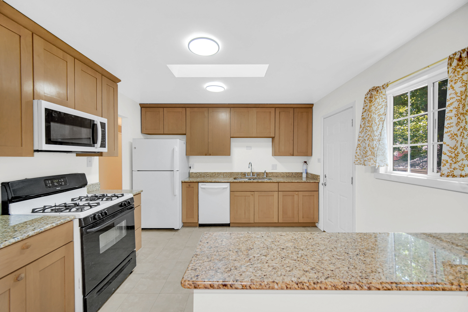 120 Indiana Street Park Forest, IL 60466 - Photo 9 of 25 a kitchen with a stove a sink and a microwave