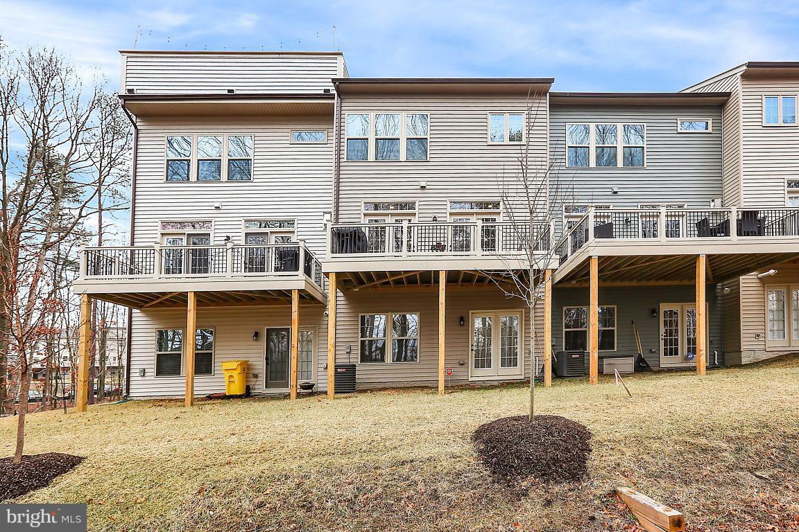 7872 Patterson Way Hanover, MD 21076 - Photo 26 of 26 a front view of a residential apartment building with a yard
