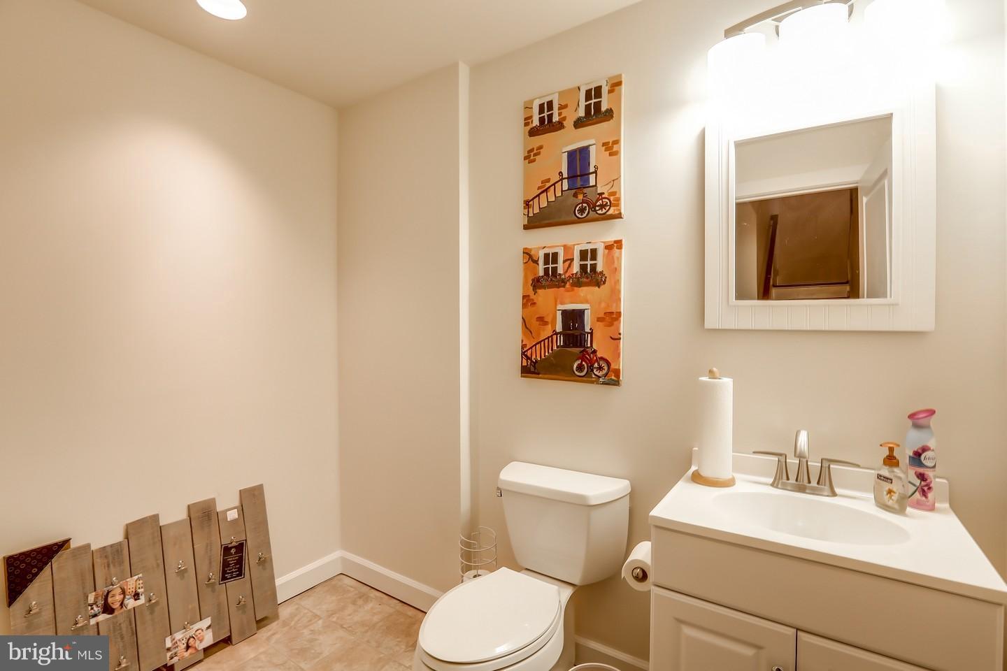7872 Patterson Way Hanover, MD 21076 - Photo 5 of 26 a bathroom with a toilet sink and mirror