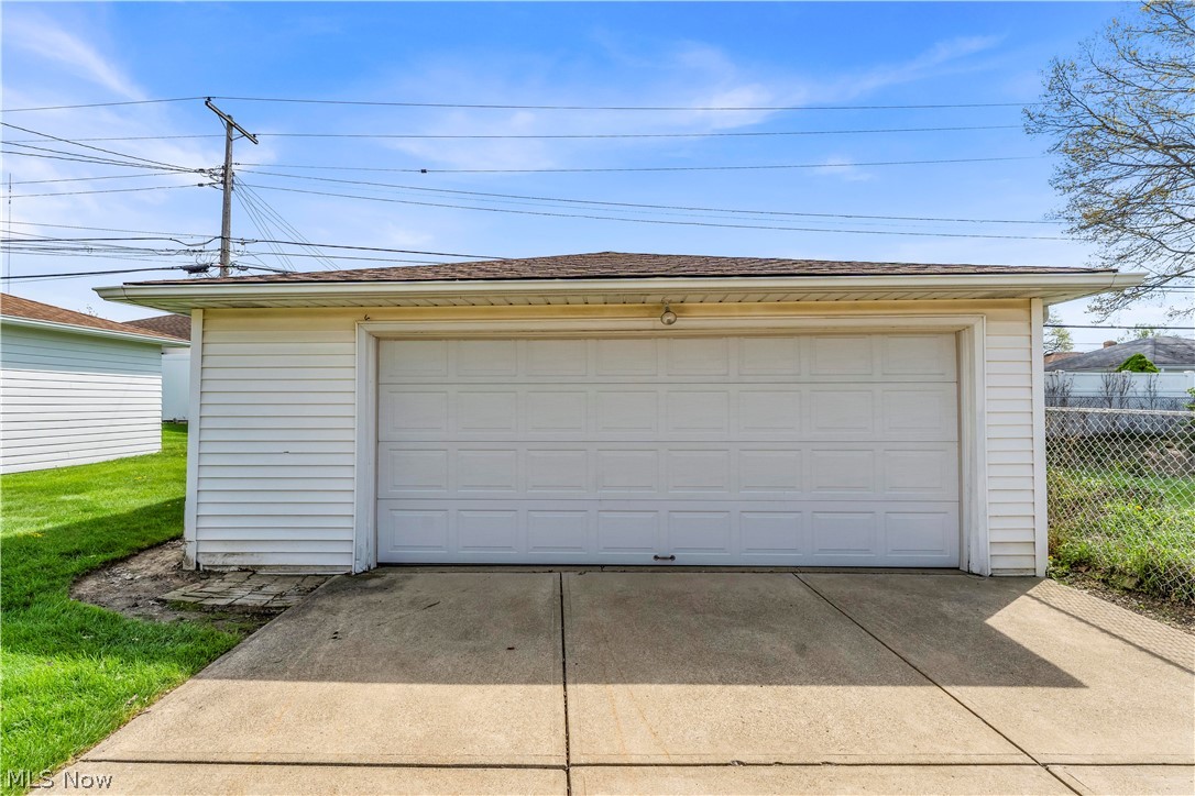 3023 Norris Avenue Cleveland, OH 44134 - Photo 36 of 41 Detached garage featuring white vinyl siding and a panel-style garage door