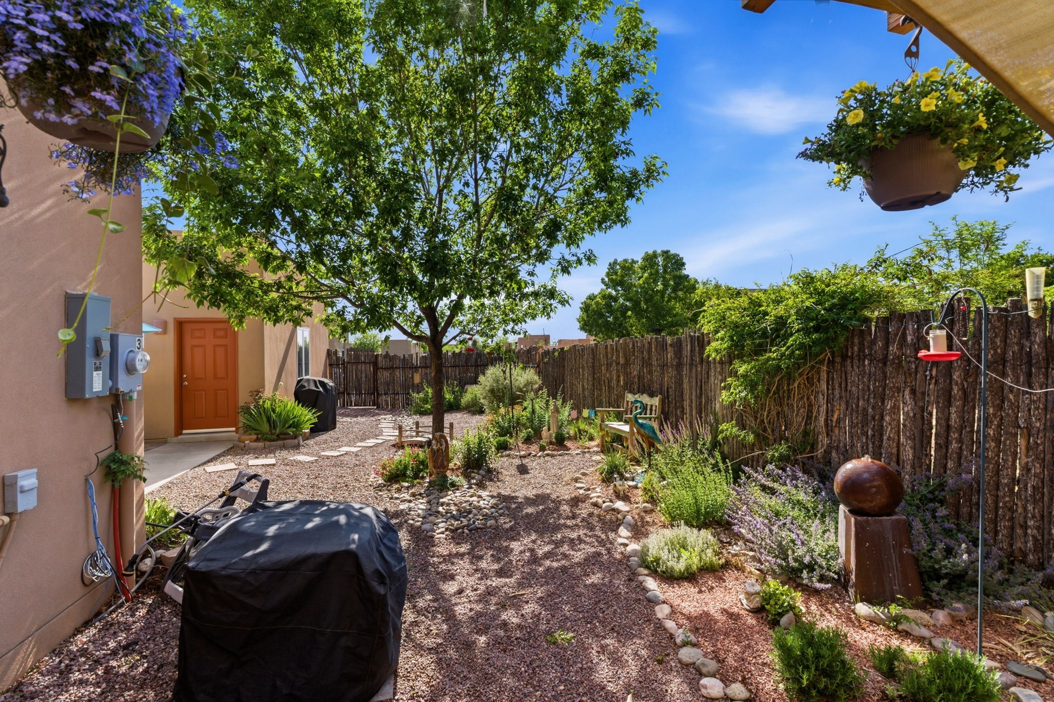 3 Silver Buckle Road Santa Fe, NM 87508 - Photo 7 of 34 Beautiful xeriscape backyard with covered portal and gray water irrigation system