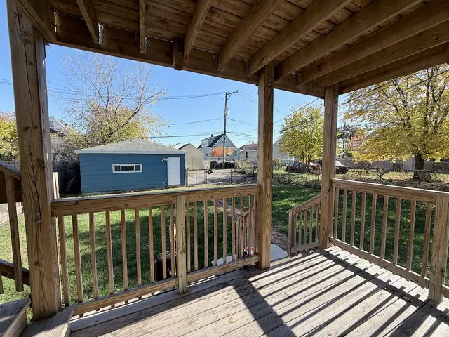 a view of a balcony with wooden floor