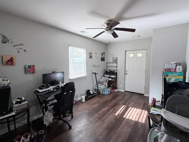 a view of a workspace with furniture and a window