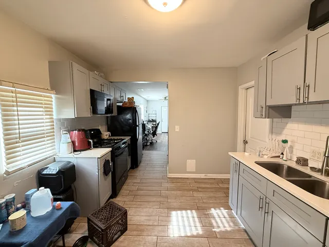 a kitchen with stainless steel appliances kitchen island granite countertop a sink and cabinets