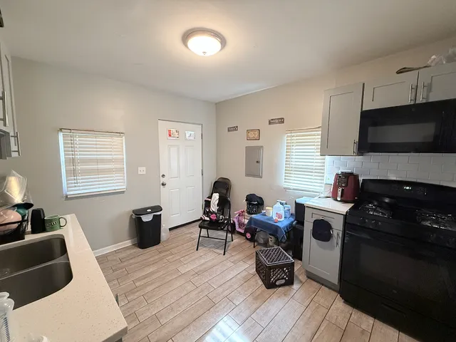a living room with furniture a window and a flat screen tv