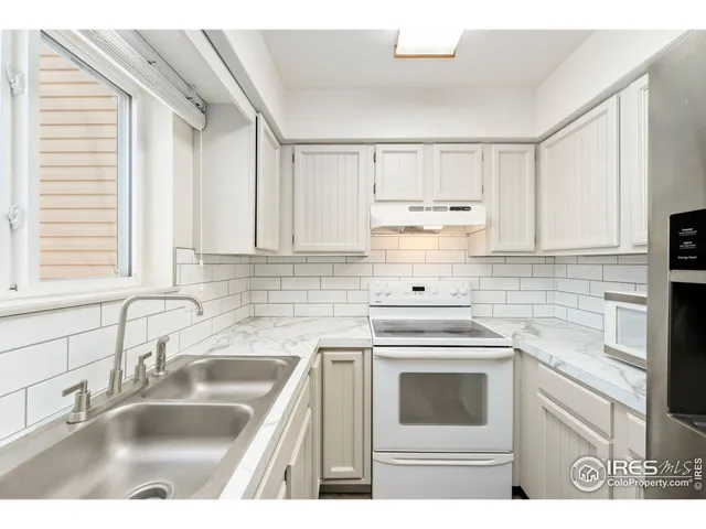 a kitchen with cabinets a sink and appliances