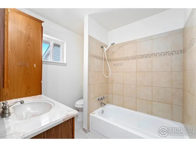 a bathroom with a tub a sink and a shower