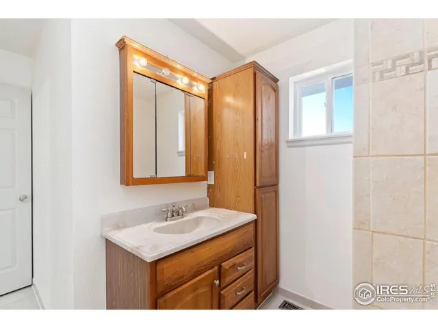 a bathroom with a sink a mirror and a shower
