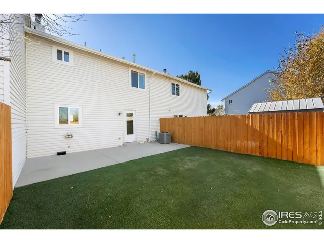 a view of a backyard with wooden fence