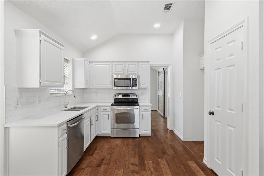 11313 Canoe Road Frisco, TX 75035 - Photo 11 of 40 Kitchen and Pantry View, the Kitchen also features beautiful wood flooring.