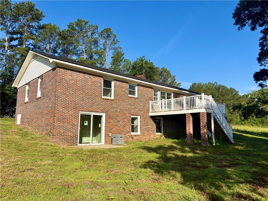 351 Randys Road Westminster, SC 29693 - Photo 7 of 30 A brick dwelling with a spacious deck overlooking a verdant landscape.
