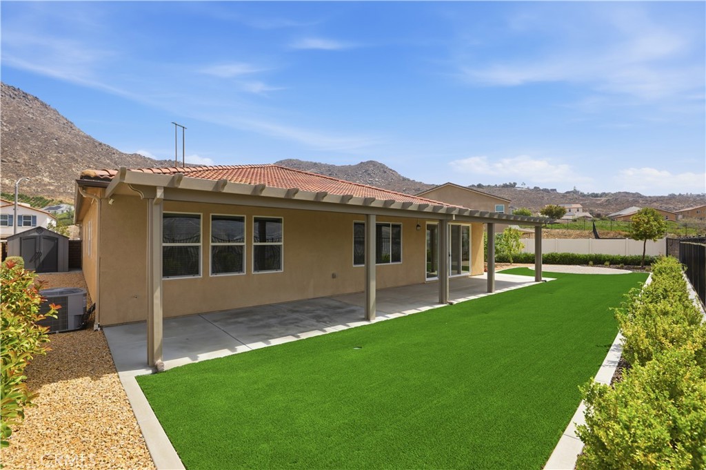 21159 Blue Jeans Court Riverside, CA 92507 - Photo 52 of 63 a view of a house with a yard and a porch