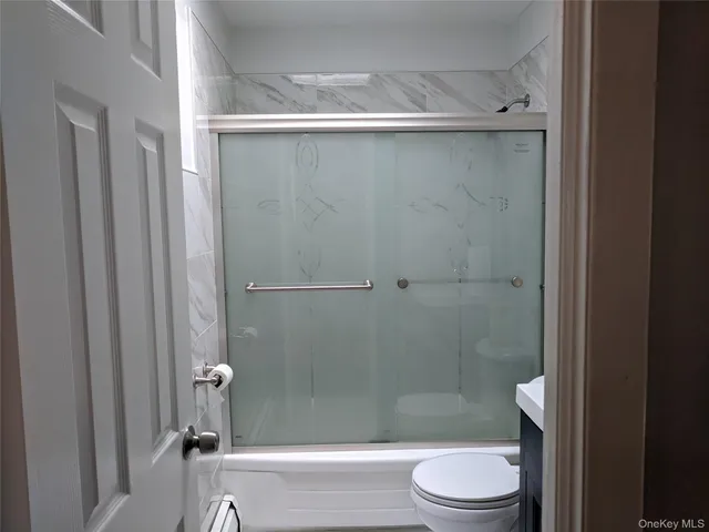 a bathroom with a shower and a toilet